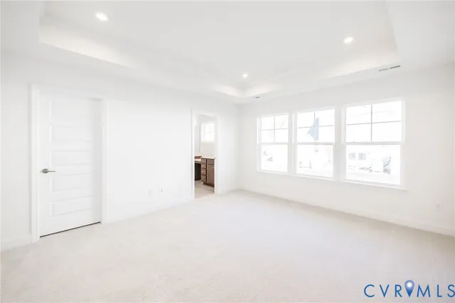 an empty room with windows and entrance