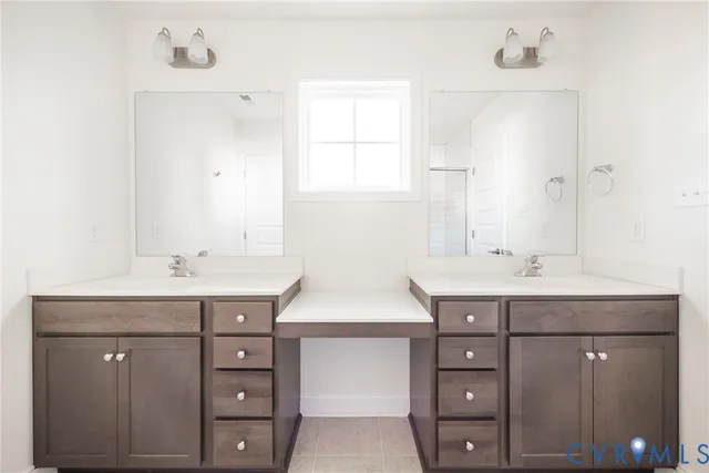 a spacious bathroom with a granite countertop sink and a mirror