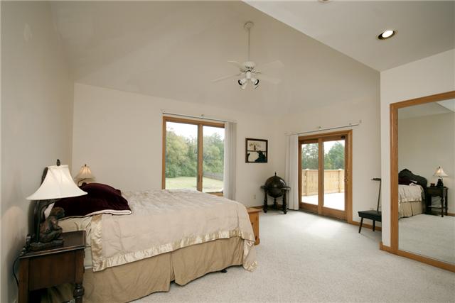 245 Quarry Road Mount Juliet, TN 37122 - Photo 11 of 19 The master suite features a vaulted ceiling, access to the rear deck, his and hers walk-in closets, separate vanities, a jacuzzi tub and a separate standing shower (with a heated fan to keep you warm when you exit the shower!).