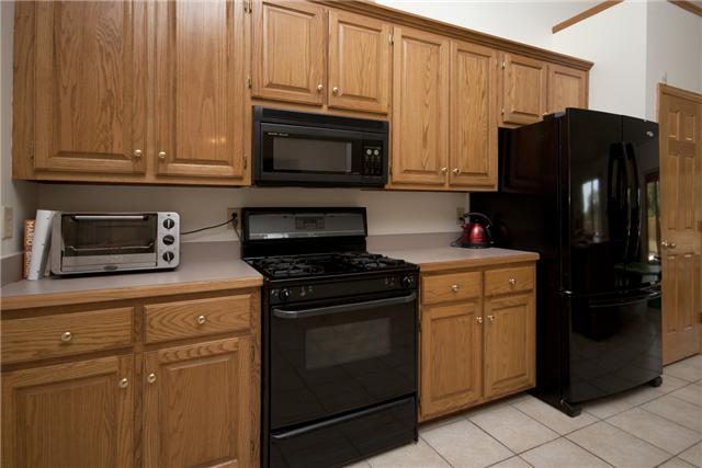245 Quarry Road Mount Juliet, TN 37122 - Photo 5 of 19 The kitchen has all black appliances which will remain with the home. (Gas stove, refrigerator, microwave and dishwasher).