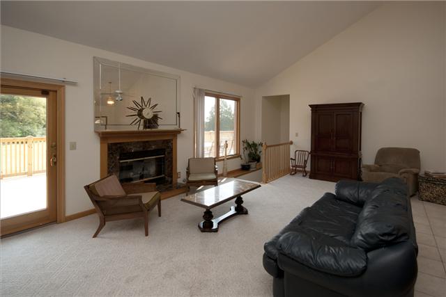 245 Quarry Road Mount Juliet, TN 37122 - Photo 7 of 19 The living room is a combined space with the kitchen with vaulted 20ft ceilings,a wood-burning fireplace, access to the deck (perfect for entertaining!), as well access to the partially finished basement.