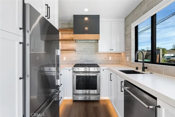 a kitchen with a sink and a stove top oven