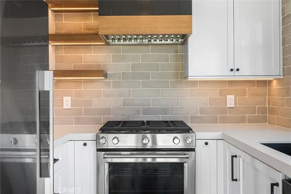 a stove top oven sitting inside of a kitchen