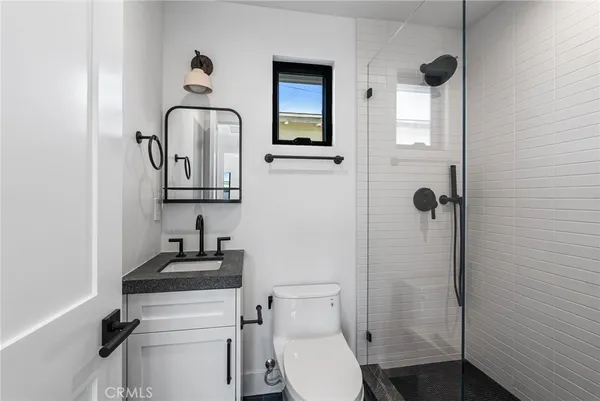 a bathroom with a toilet sink and shower