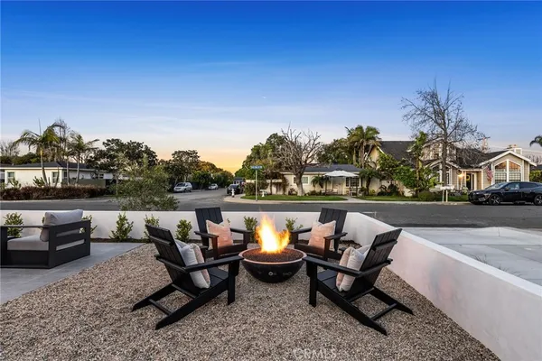 a terrace with outdoor seating and trees