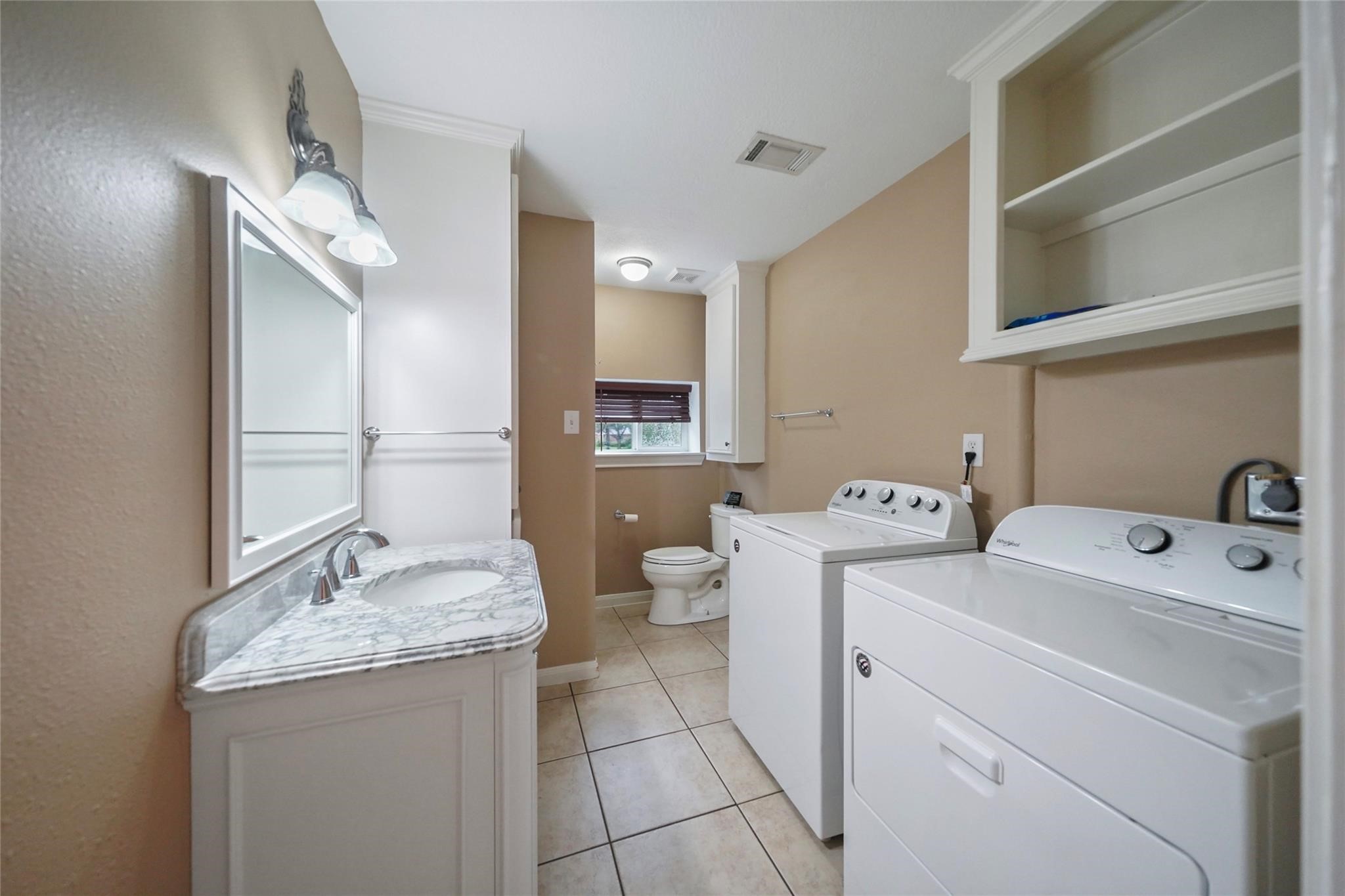30720 Waller Spring Creek Road Waller, TX 77484 - Photo 15 of 22 Secondary bathroom featuring a single vanity, shower, and convenient washer/dryer area.