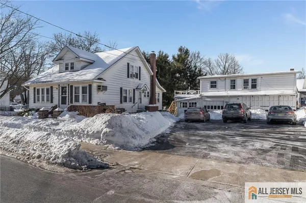 a view of a house with a yard covered in snow