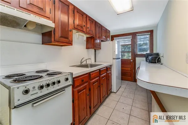 a kitchen with stainless steel appliances a stove a sink and a microwave