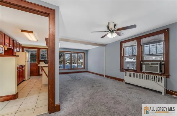 a view of livingroom with furniture hardwood floor and a ceiling fan