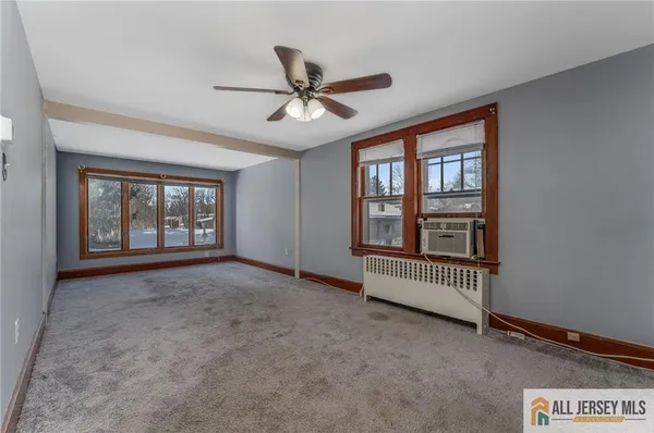 a view of livingroom with a ceiling fan and window