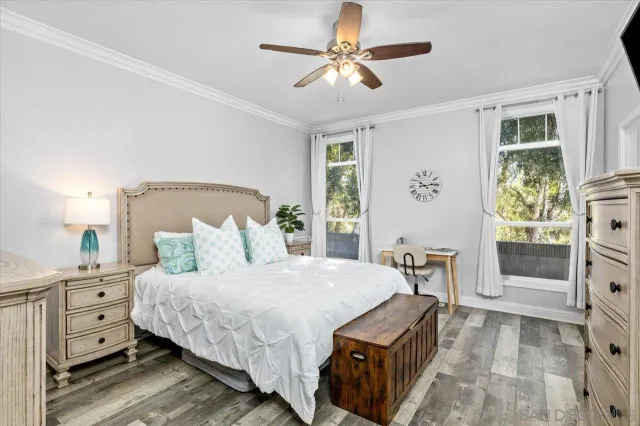 a bedroom with a bed a television and dresser