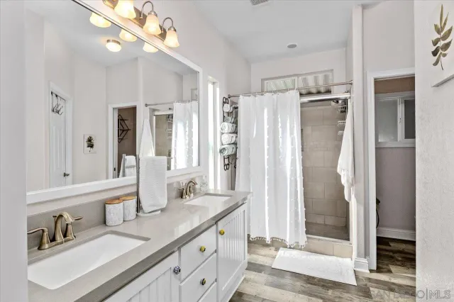 a bathroom with a sink toilet and shower