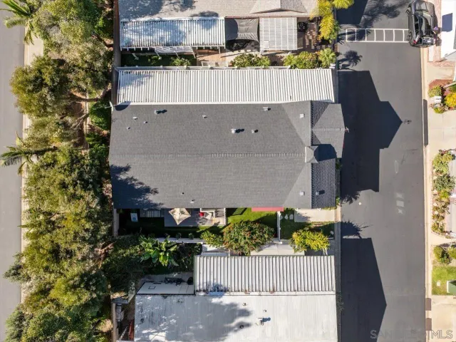 a view of a chair and table in backyard of the house