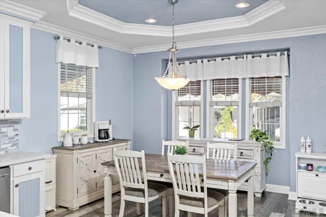 a dining room with furniture a chandelier and window
