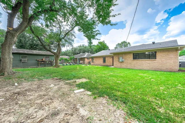 a front view of house with a garden