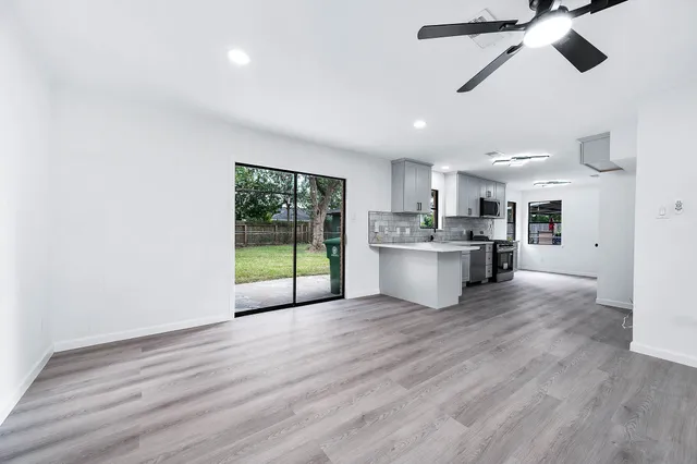 a view of a kitchen with a sink and a window