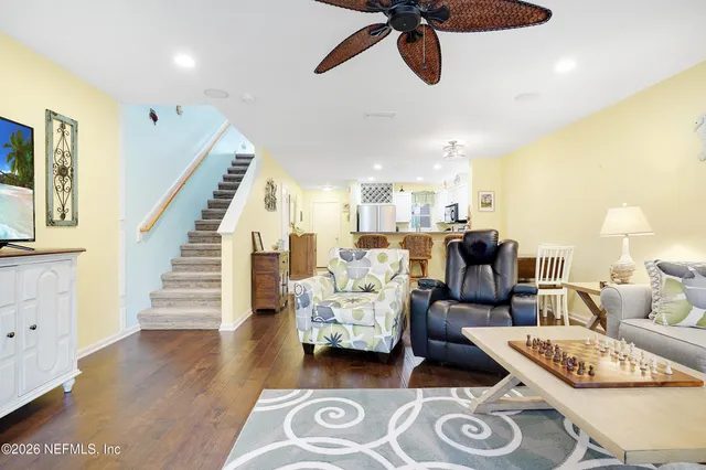 a living room with furniture and wooden floor