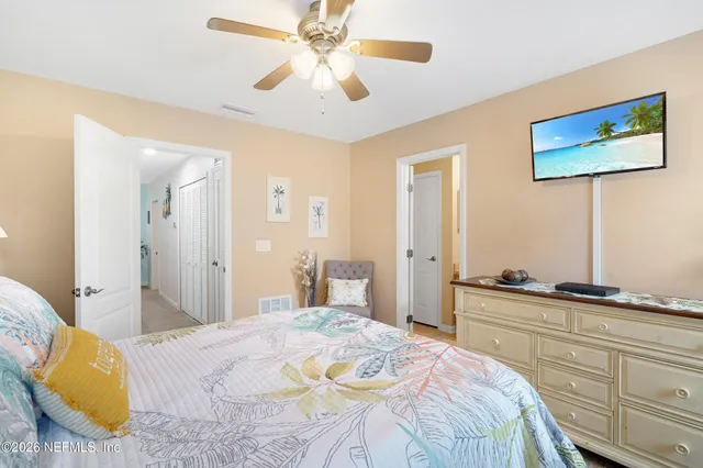 a bedroom with a bed and ceiling fan