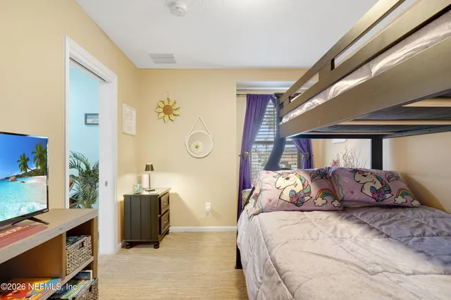 a bedroom with a bed dresser and a window