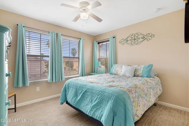 a bedroom with a large bed and a large window