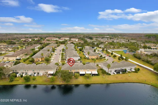 an aerial view of a house with lake view