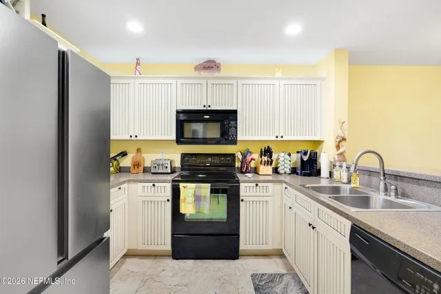 a kitchen with a sink stove and refrigerator