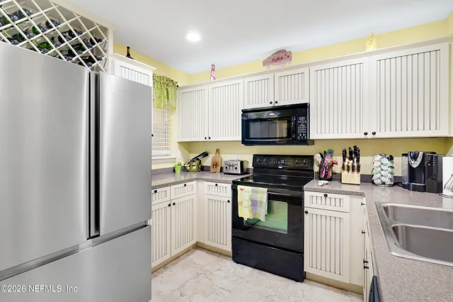 a kitchen with stainless steel appliances a stove sink microwave and cabinets