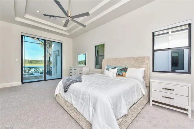 a large bed sitting in a bedroom next to a window