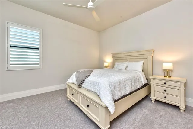 a bed room with a bed and a night stand