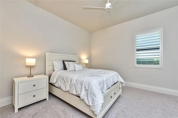 a bedroom with a bed and a night stand