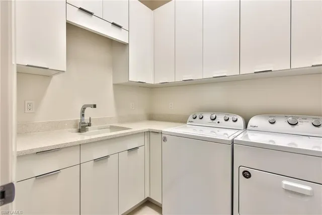 a utility room with sink dryer and washer