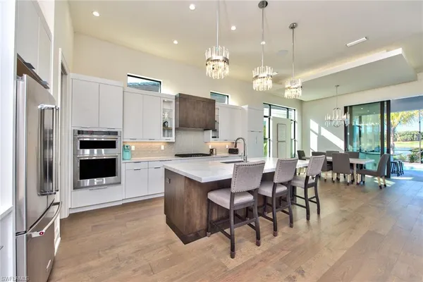 a large kitchen with a table and chairs