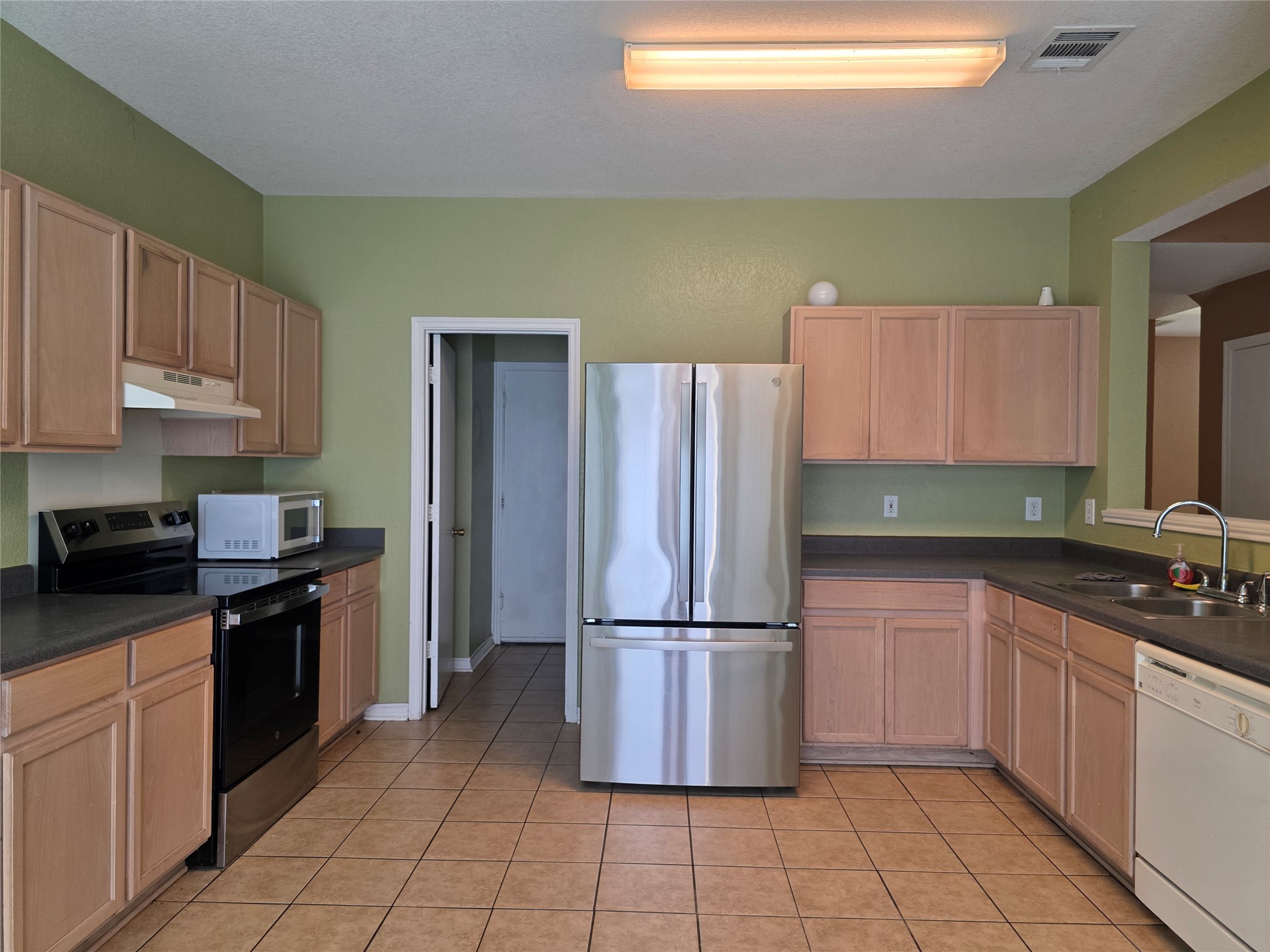 189 Ruidoso Road Kyle, TX 78640 - Photo 9 of 31 A well-equipped kitchen offers ample cabinet storage and modern appliances, perfect for everyday meals.