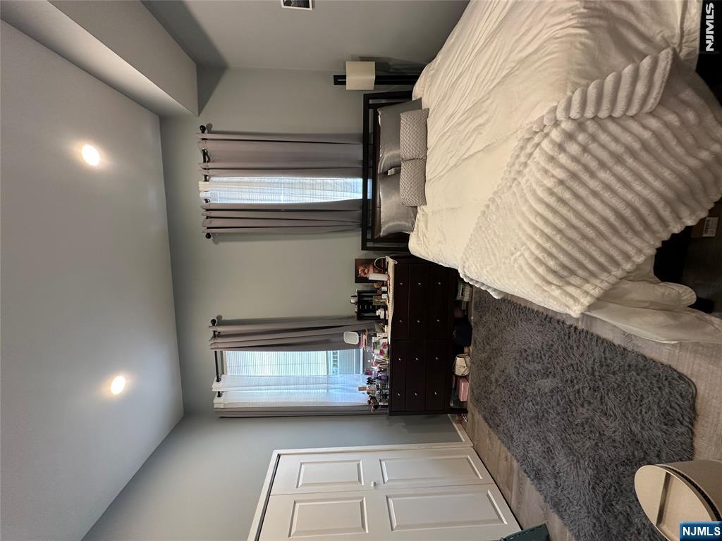 128 Locust Avenue, Unit D Wallington, NJ 07057 - Photo 6 of 8 a spacious bathroom with a sink and a large mirror