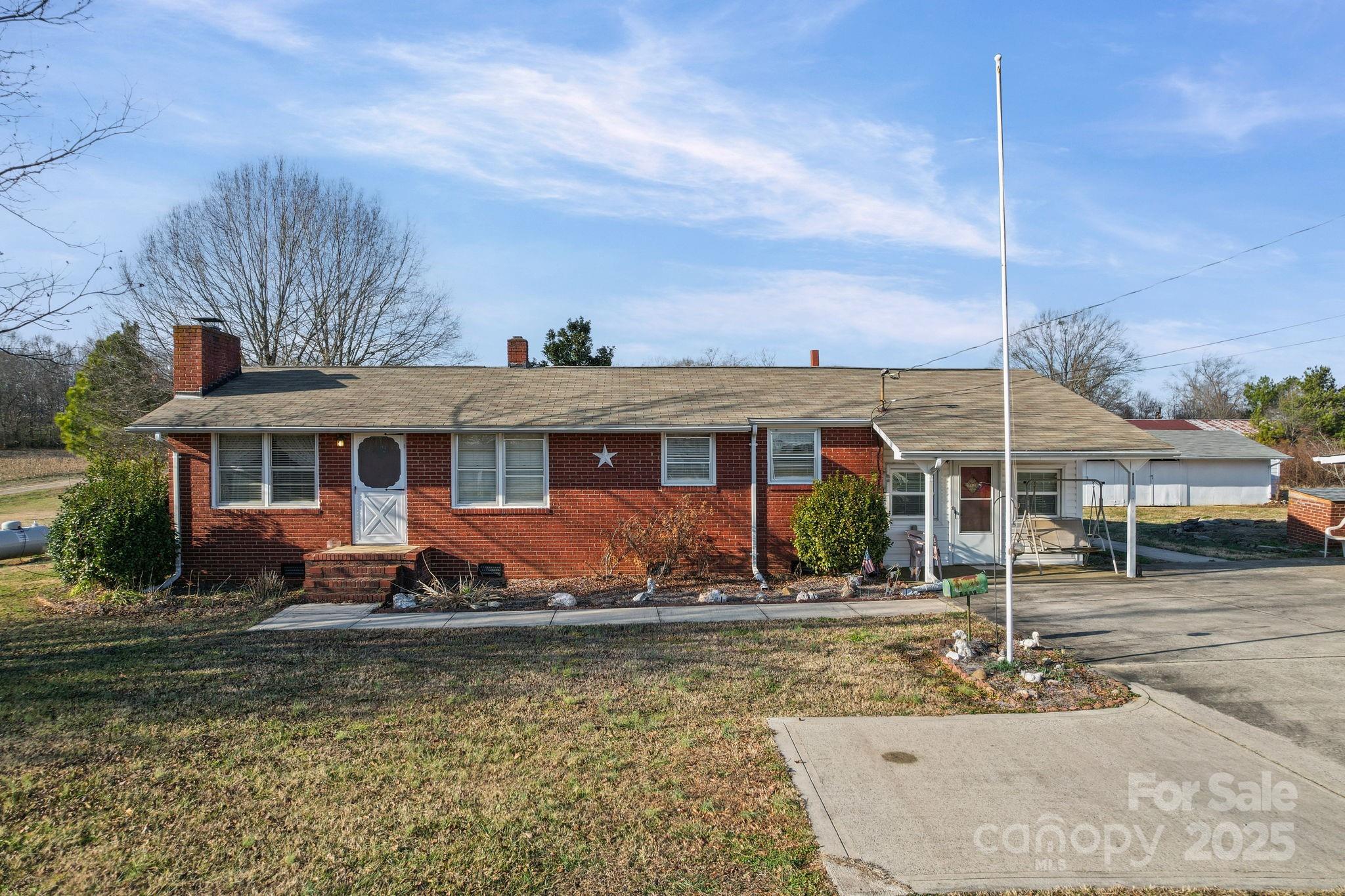2601-2617 Olive Branch Road Monroe, NC 28110 - Photo 14 of 30 a front view of a house with garden