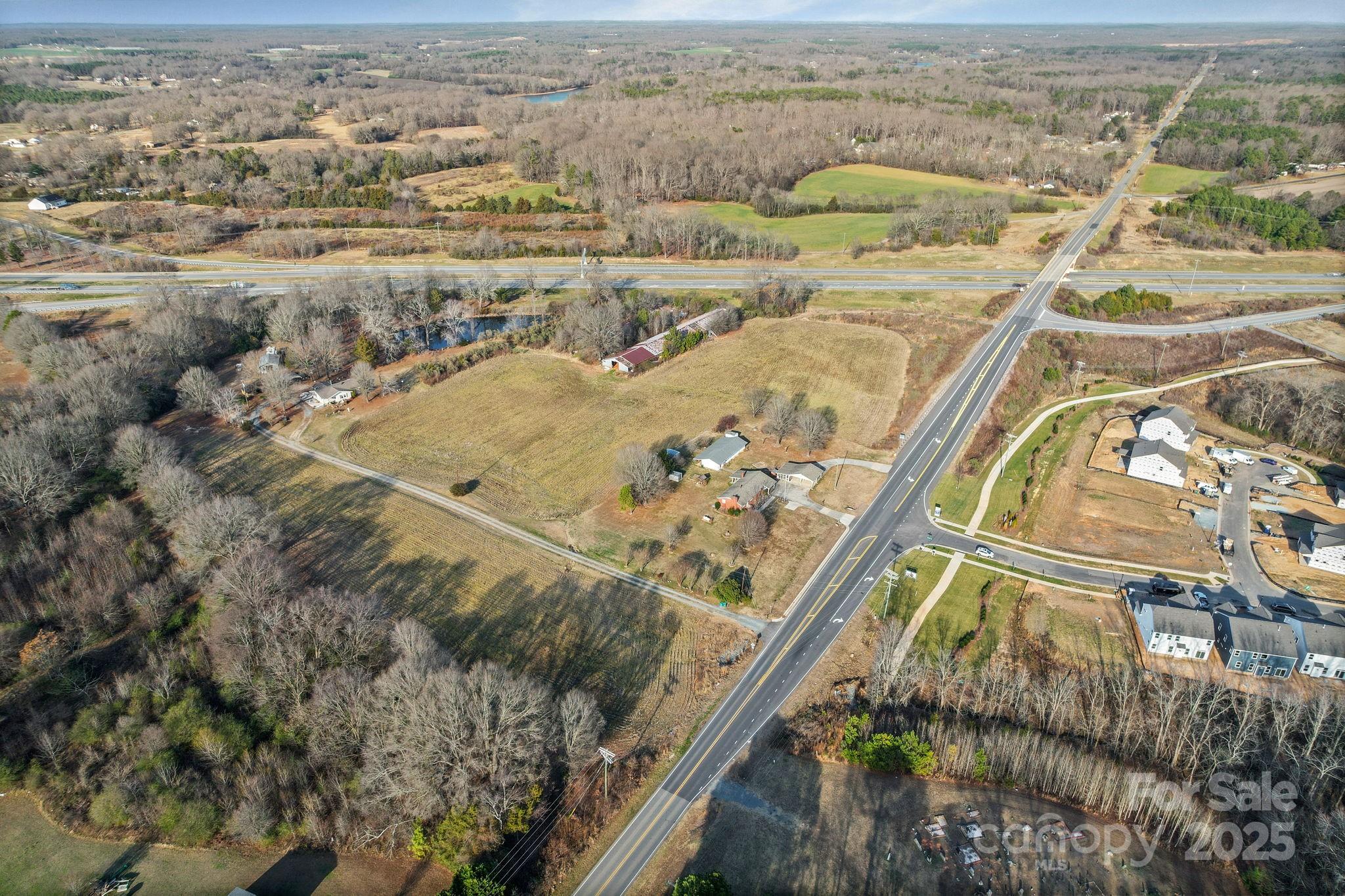 2601-2617 Olive Branch Road Monroe, NC 28110 - Photo 15 of 30 an aerial view of a house with a yard and lake view