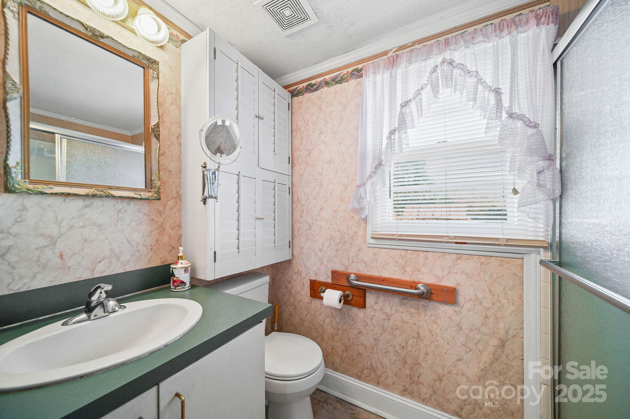 2601-2617 Olive Branch Road Monroe, NC 28110 - Photo 20 of 30 a bathroom with a granite countertop sink toilet a mirror and shower