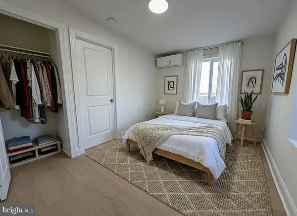 a bedroom with a bed and walk in closet