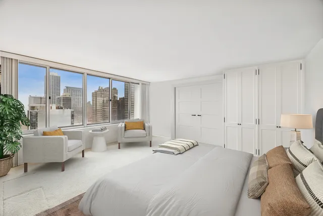 a bedroom with a bed and a large window