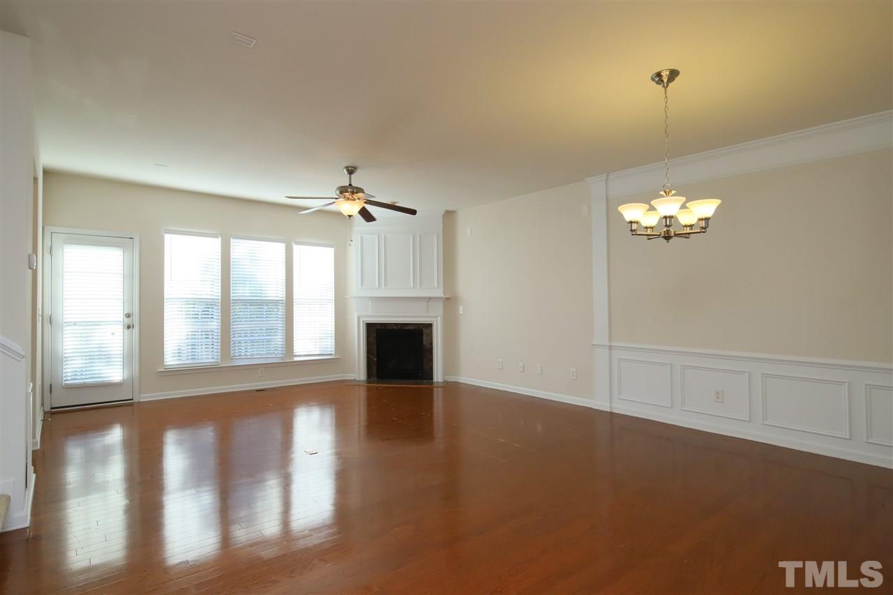 2619 Laurel Cherry Street Raleigh, NC 27612 - Photo 11 of 30 a view of an empty room with chandelier fan and fire place