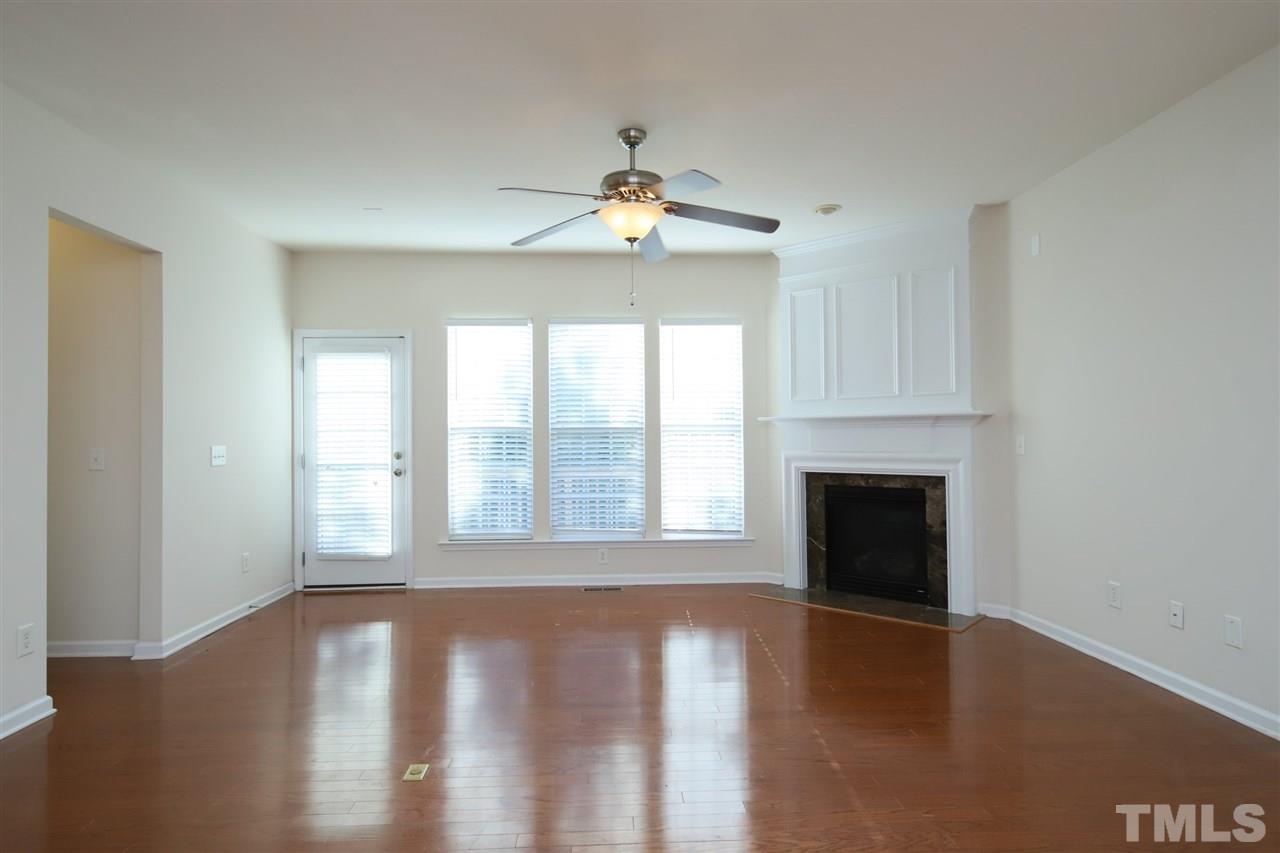2619 Laurel Cherry Street Raleigh, NC 27612 - Photo 12 of 30 a view of an empty room with wooden floor and a window