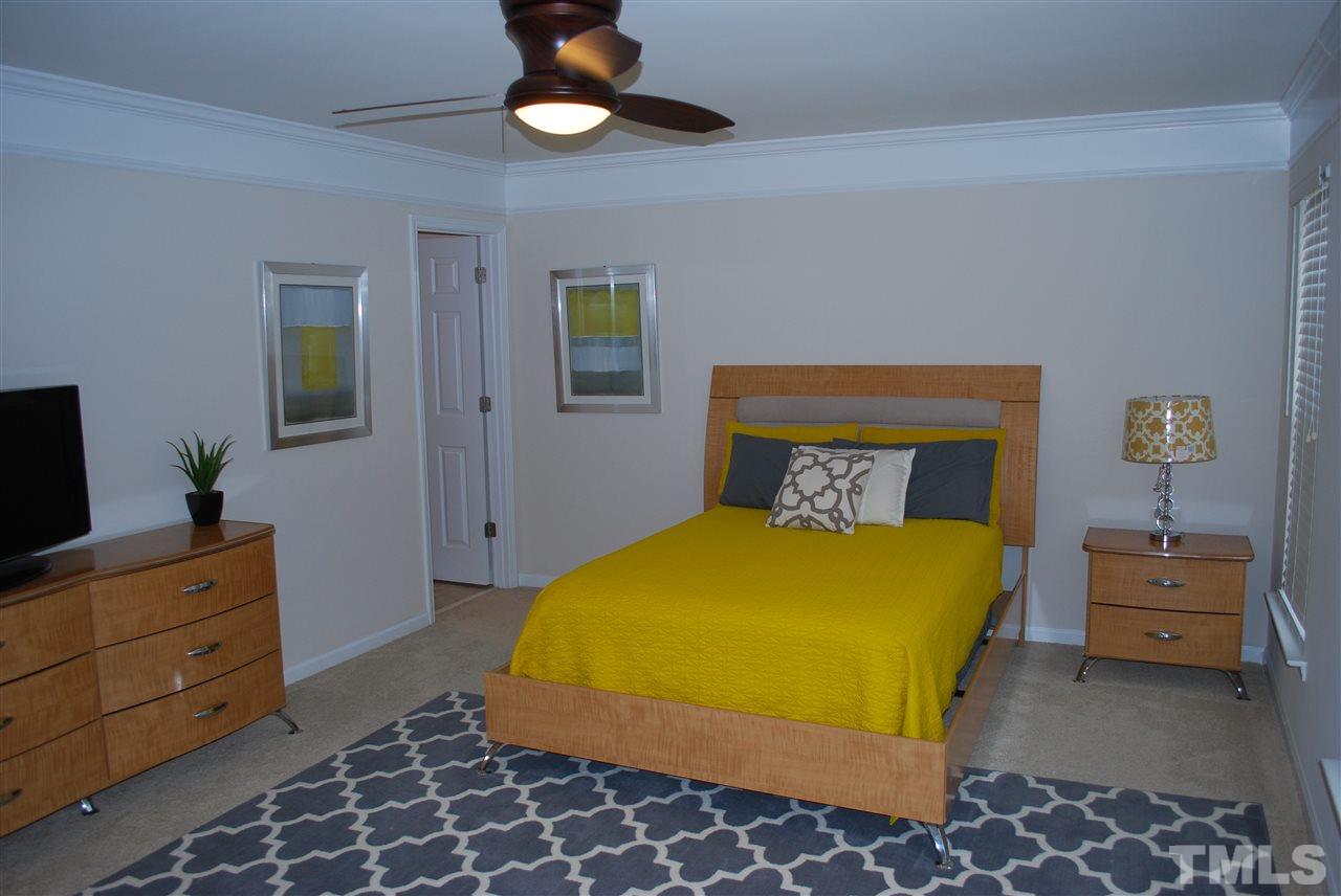 2619 Laurel Cherry Street Raleigh, NC 27612 - Photo 17 of 30 a bedroom with a bed and furniture
