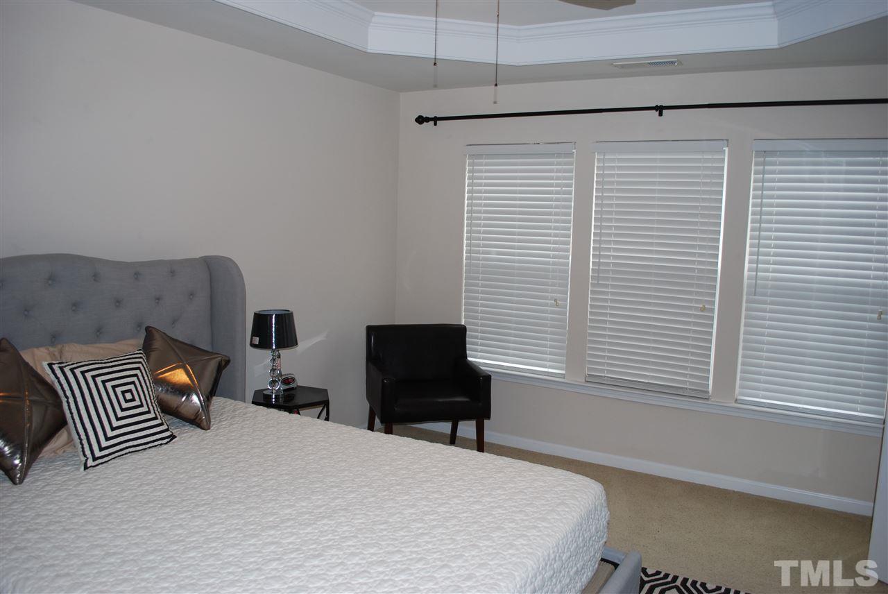 2619 Laurel Cherry Street Raleigh, NC 27612 - Photo 21 of 30 a bedroom with a bed and a window