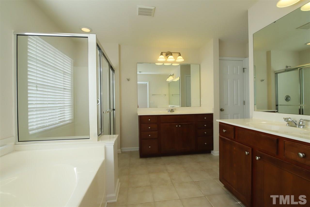 2619 Laurel Cherry Street Raleigh, NC 27612 - Photo 22 of 30 a spacious bathroom with a tub sink and mirror