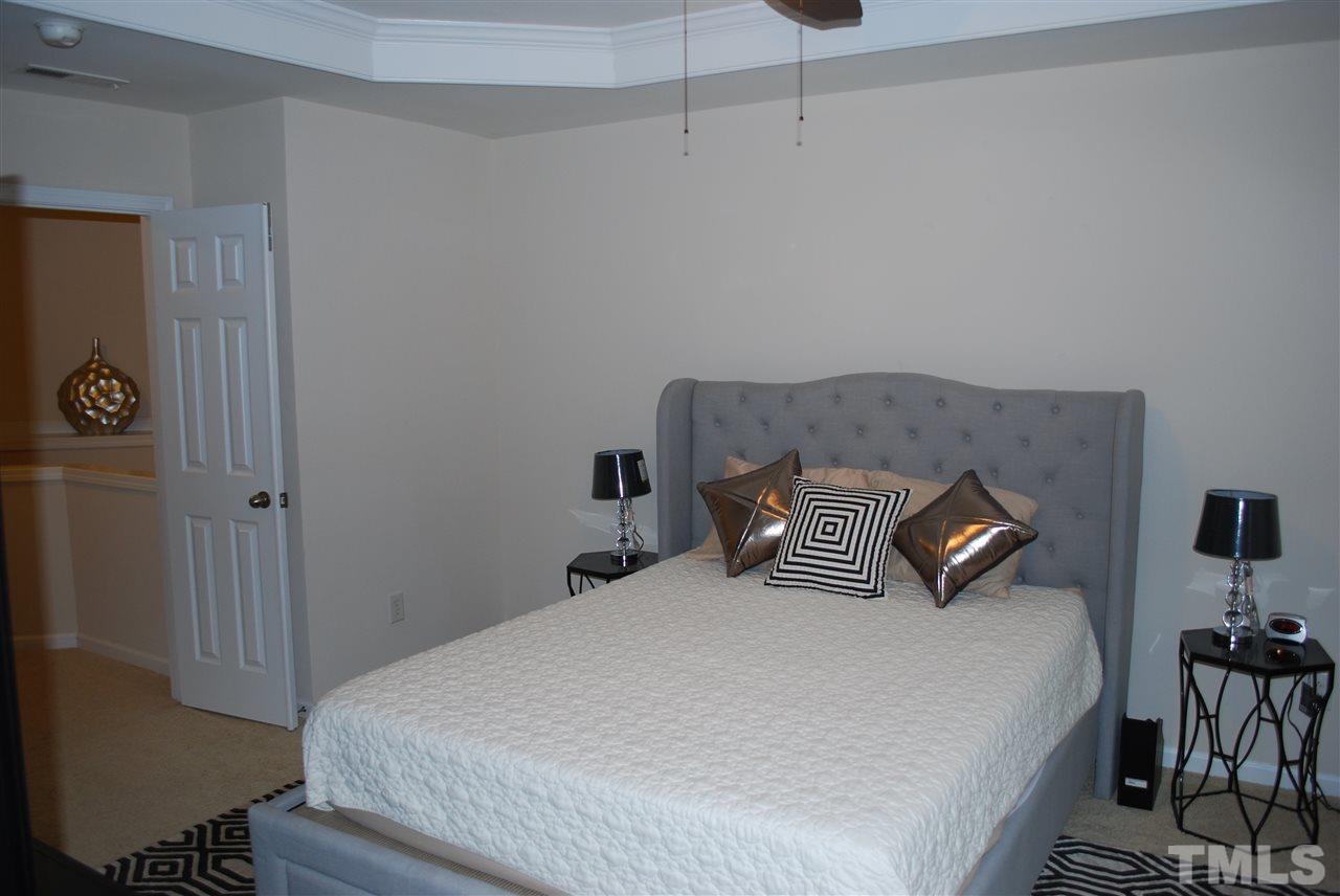 2619 Laurel Cherry Street Raleigh, NC 27612 - Photo 24 of 30 a bedroom with a bed and furniture