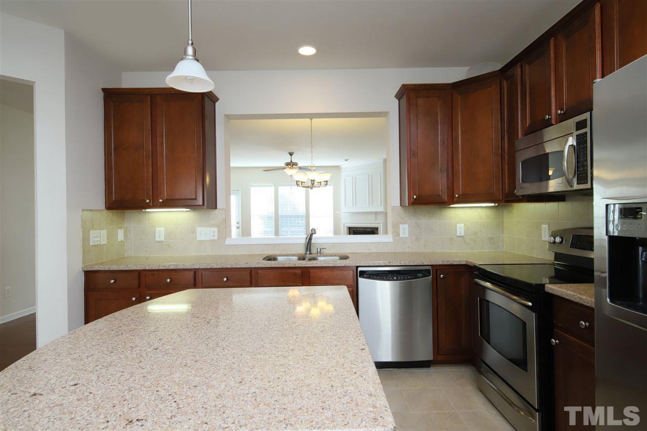 2619 Laurel Cherry Street Raleigh, NC 27612 - Photo 7 of 30 a kitchen with stainless steel appliances granite countertop a sink and a stove
