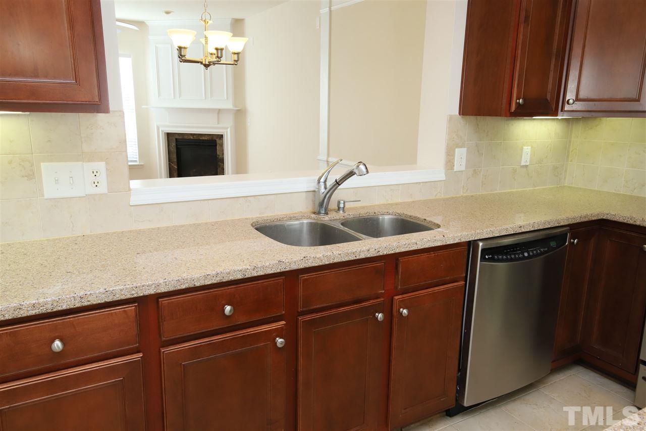 2619 Laurel Cherry Street Raleigh, NC 27612 - Photo 8 of 30 a kitchen with granite countertop a sink cabinets and stainless steel appliances