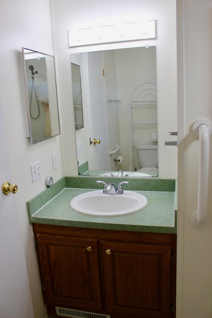 930 Rosedale Avenue, Unit 35 Capitola, CA 95010 - Photo 11 of 18 a bathroom with a granite countertop sink a mirror and a