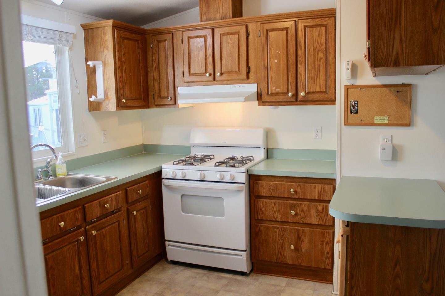 930 Rosedale Avenue, Unit 35 Capitola, CA 95010 - Photo 4 of 18 a kitchen with granite countertop cabinets stainless steel appliances and a sink