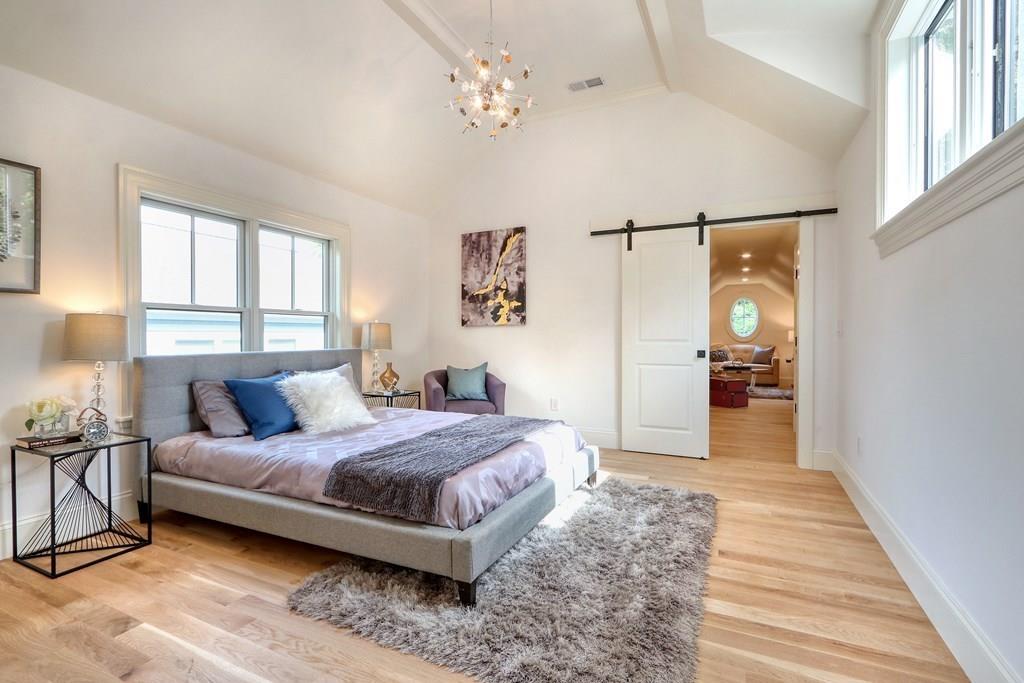 135 Waban Hill Road North Newton, MA 02467 - Photo 23 of 36 a bedroom with a bed chandelier and a window